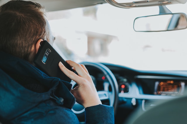 Someone driving while talking on the phone