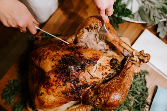 Someone Cutting into a turkey