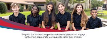 Multiple children out side of a school in school uniforms