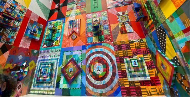 A wall of abstract paintings