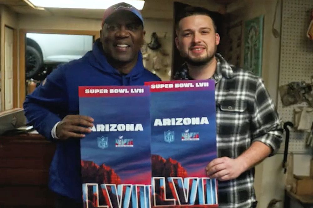 Two men holding up giant super bowl tickets