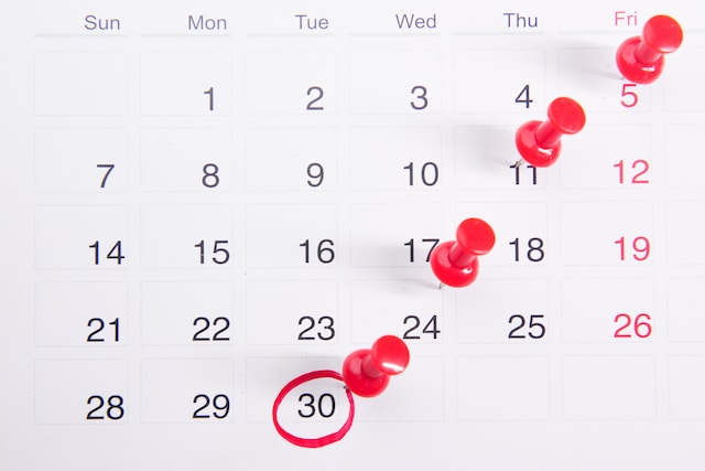 A calendar with pins in it