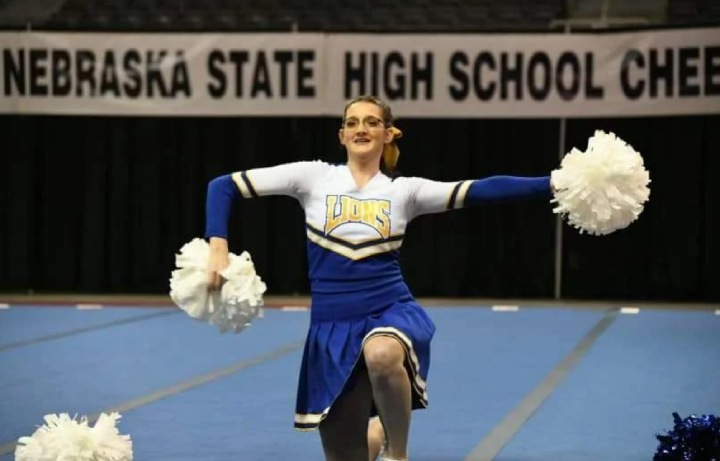 Cheerleader cheering with Pom Poms